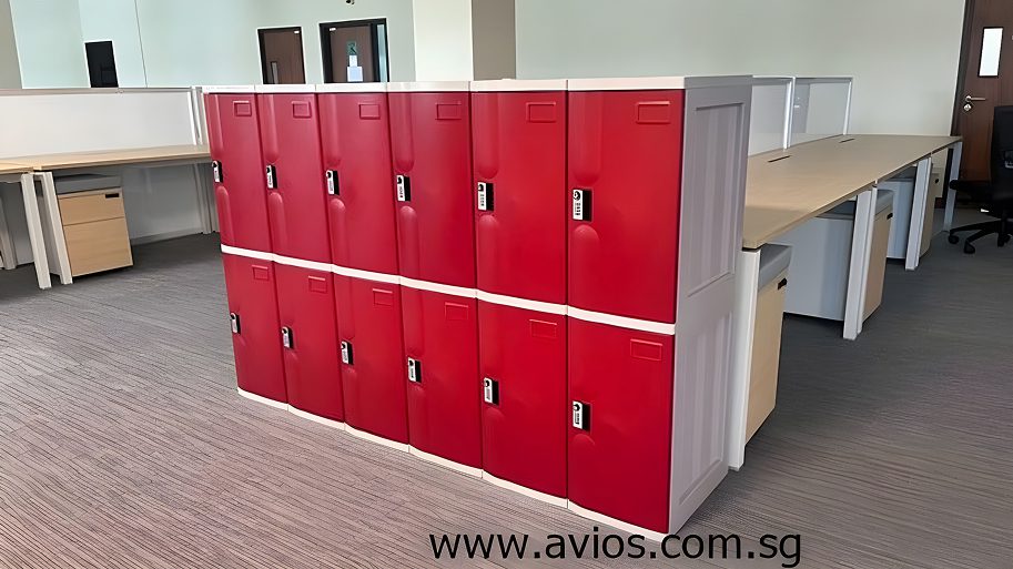 Avios | Why ABS Lockers Are Gaining Popularity in Singapore’s Commercial Spaces A row of two-tier red lockers made of sturdy ABS plastic, placed in the middle of a modern office space. Equipped with digital security locks, this installation is an ideal choice from an abs lockers singapore provider for employee storage facilities.