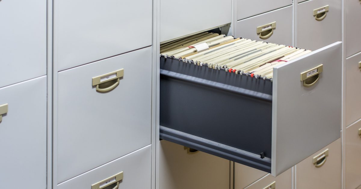 Open metal office storage cabinet filled with files and folders