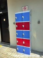 Colorful blue and red storage lockers with a no smoking sign above them.